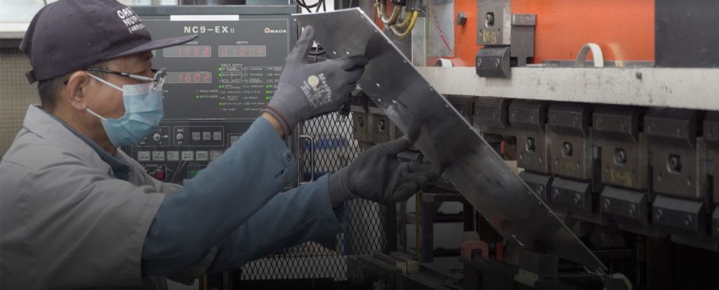 A man bending sheet metal.